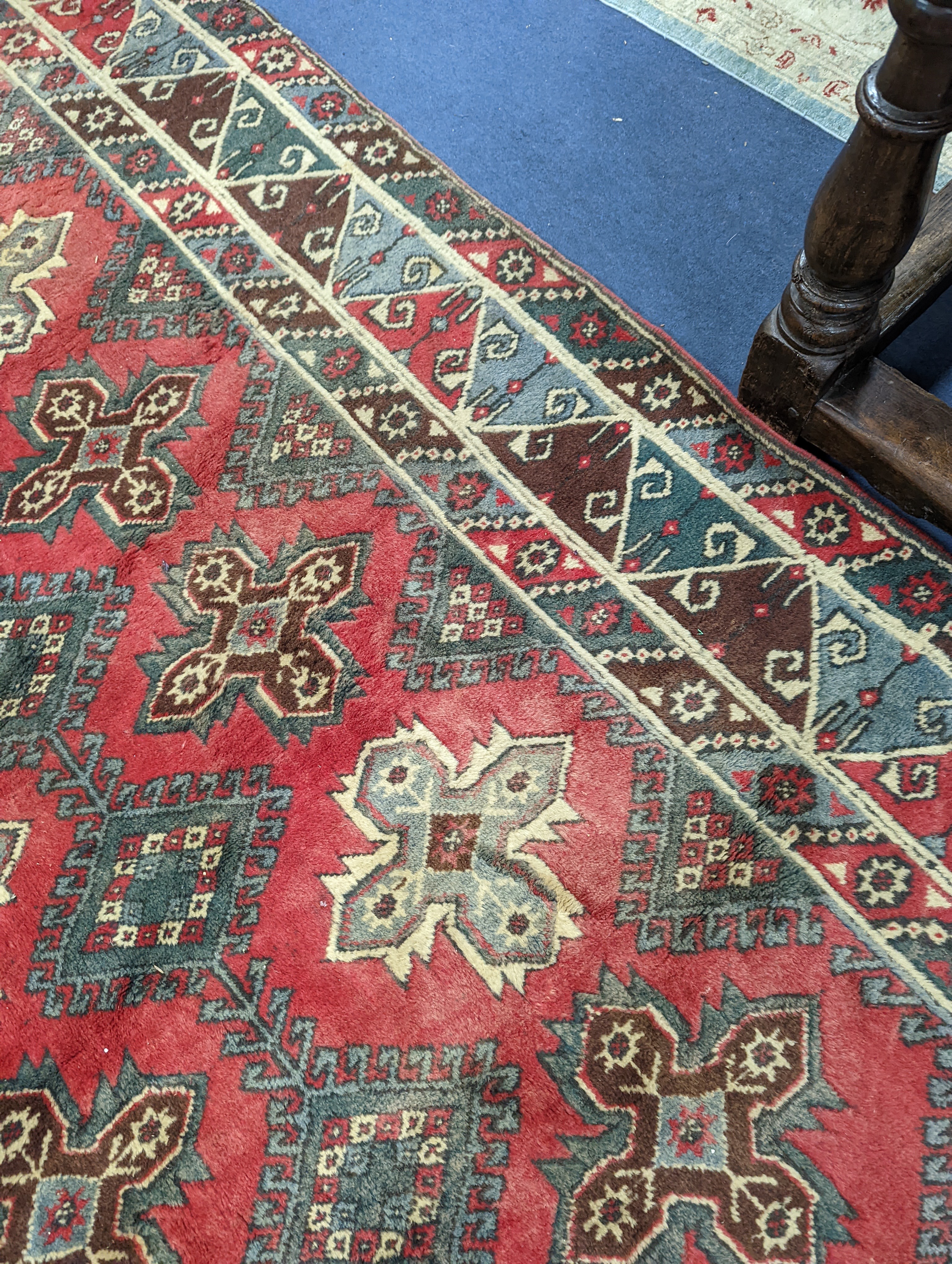 A Caucasian style red ground carpet, 286 x 210cm
